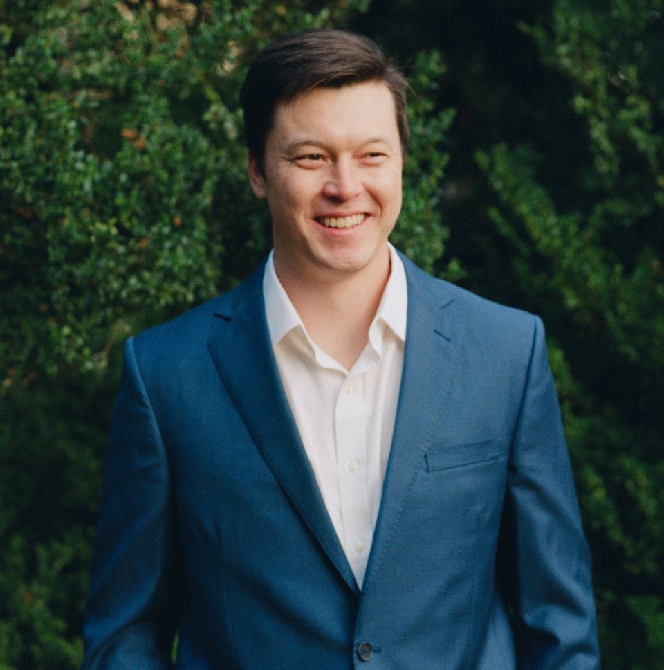 Zed Higgs in a blue suit outdoors
